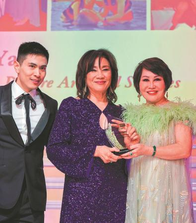 Janet Yang (center) is presented with the Outstanding Asian American Women Who Dared Award by Yue-Sai Kan (right) on Feb 27 in Los Angeles. (CHINA DAILY)