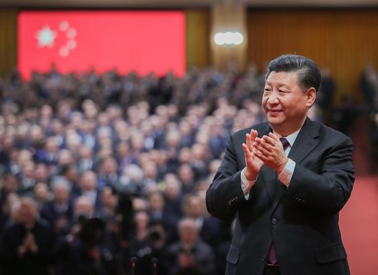 Chinese President Xi Jinping, also general secretary of the Communist Party of China Central Committee and chairman of the Central Military Commission, applauds the personnel awarded with medals during a grand gathering to celebrate the 40th anniversary of China's reform and opening-up at the Great Hall of the People in Beijing, capital of China, Dec. 18, 2018. (Xinhua/Xie Huanchi)