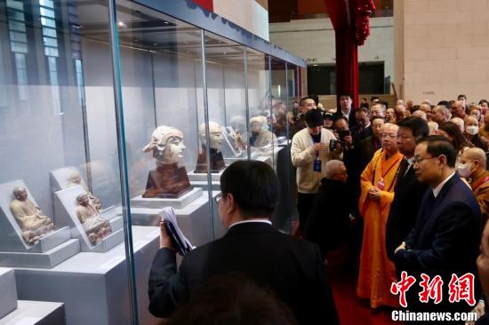 Guests attending the donation ceremony view the Buddhist relics at the National Museum of China in Beijing on Monday. (Photo/China News Service)