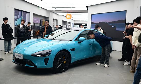 Xiaomi's first electric vehicle put on display, drawing crowds