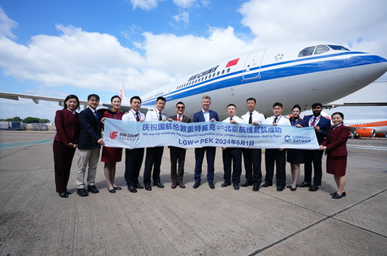 Jonathan Pollard, chief commercial officer at London Gatwick Airport (center), and Xia Baohui, general manager of Air China's London office, (sixth from left), pose with Air China personnel at London Gatwick Airport on June 1. (Photo provided to China Daily)