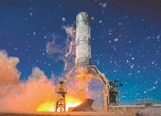 A VTVL-1 experimental rocket ignites as it prepares to lift off at Jiuquan Satellite Launch Center. (Photo provided to China Daily)