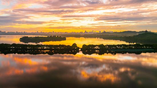 West Lake glows in morning light in E China