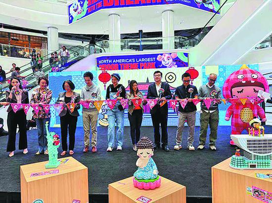 Maisie Ho (fourth from right), director of the Hong Kong Economic and Trade Office in New York, Prudence Mak (center), creator of Fatina Dreams and founder of Chocolate Rain, and other guests cut the ribbon at the exhibition in New Jersey. (PHOTO BY MINGMEI LI/CHINA DAILY)