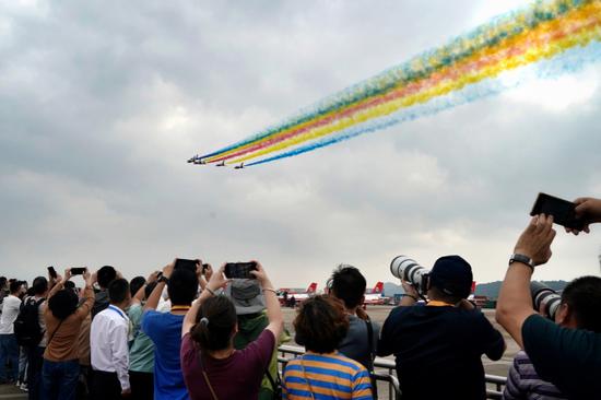 The August 1st Air Demonstration Team makes contrails to celebrate the 75th anniversary of the founding of the People's Liberation Army Air Force during a training session on Monday in Zhuhai, Guangdong province. The 15th China International Aviation and Aerospace Exhibition, also known as the Zhuhai Airshow, starts on Tuesday. (ZHOU GUOQIANG/FOR CHINA DAILY)