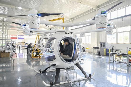 A technician tests an electric vertical take-off and landing (eVTOL) aircraft in Hefei, Anhui province, which is bolstering the development of new quality productive forces. (CHINA DAILY)