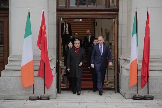 Chinese Foreign Minister Wang Yi meets with Irish Taoiseach Micheal Martin in Dublin on Monday. (Photo by Xing Yi/China Daily)