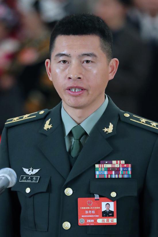 Lieutenant Colonel Zhang Dongxu, commander of a combined combat battalion of the People's Liberation Army Ground Force, also a deputy to the 14th National People's Congress, attends a group interview ahead of the opening meeting of the third session of the 14th NPC at the Great Hall of the People in Beijing, on March 5, 2025. (Photo by Kuang Linhua/chinadaily.com.cn)