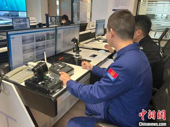 Firefighters monitor real-time footage from drones to assess the situation ahead at the command center of Xiuzhou District, in east China's Zhejiang Province in March 2025. (Photo courtesy of Xiuzhou District Fire Rescue Bureau)