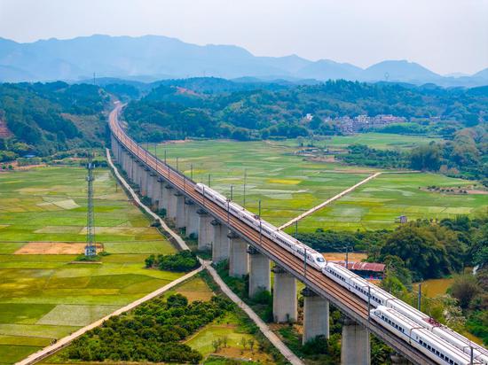 Bullet trains travel through picturesque rural area