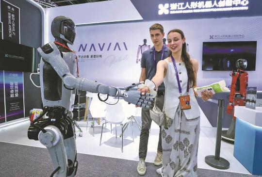 A guest shakes hands with a humanoid robot at the ongoing fourth China-CEEC Expo in Ningbo, East China's Zhejiang province. ZHANG WEI/CHINA DAILY