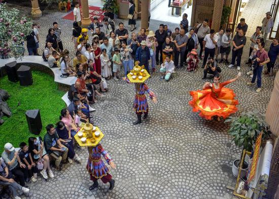 Visitors enjoy local performances and cuisine at grand bazaar in Urumqi