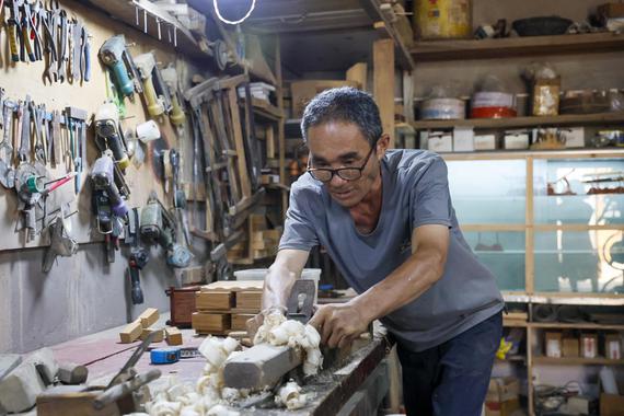After dedicating himself to furniture-making for 40 years, 59-year-old Lu Junfang now promotes wooden handicrafts via livestream from Shizuishan, Ningxia Hui autonomous region.(Photo provided to chinadaily.com.cn)