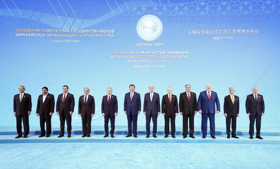 Chinese President Xi Jinping poses for a group photo with leaders attending the 24th Meeting of the Council of Heads of State of the Shanghai Cooperation Organization in Astana, Kazakhstan, July 4, 2024. (Xinhua/Ju Peng)