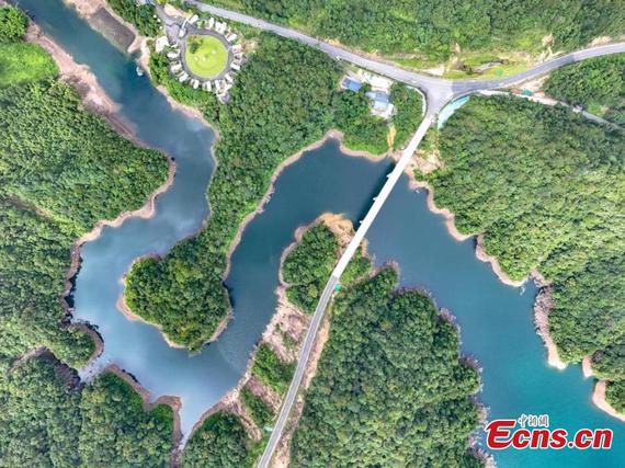An aerial view of Luhua Reservoir in Hezhou, Guangxi Zhuang Autonomous Region , shows its winding shoreline resembling a jade ribbon weaving through lush green mountains, creating a stunning ecological landscape. (Photo:China News Service/ Li Haotu)