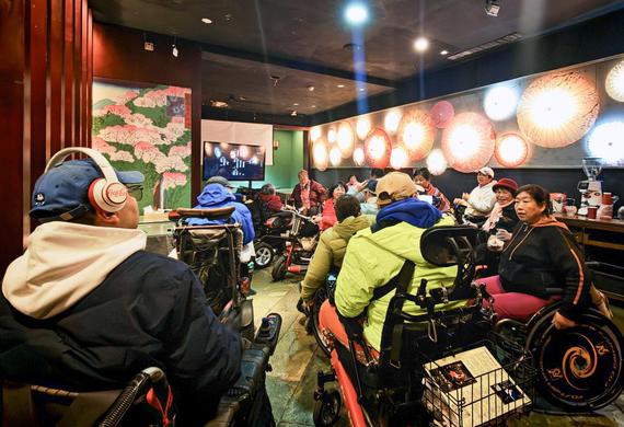Physically impaired people communicate after a film screening at Trojan Fairy restaurant in Beijing, capital of China, Oct. 26, 2025. (Xinhua/Yin Gang)