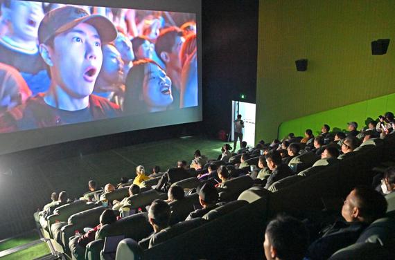 Visually-impaired people, together with their family members and volunteers, enjoy a movie at a cinema in Nanning, south China's Guangxi Zhuang Autonomous Region, Dec. 3, 2025. (Xinhua/Zhou Hua)