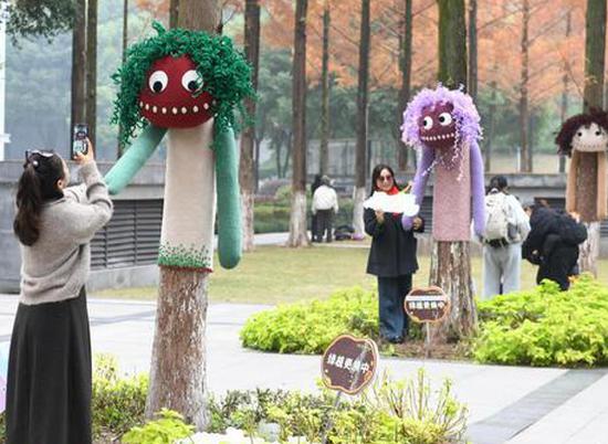 Cartoon outfits add warmth, whimsy to trees in Chongqing