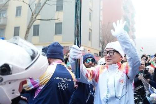 Chinese double-Olympics volunteer serves as first torchbearer as flame arrives in Italy
