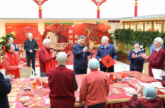 Chinese President Xi Jinping, also general secretary of the Communist Party of China Central Committee and chairman of the Central Military Commission, talks with elderly residents while visiting an apartment complex for seniors in Xicheng District of Beijing, capital of China, Feb. 10, 2026. Xi visited primary-level officials and residents in Beijing during a two-day inspection tour from Monday to Tuesday. (Photo by Feng Yongbin/Xinhua)