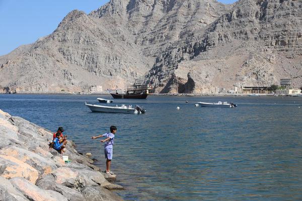 Children play by the shore at Kumzar Village in Oman, Feb. 19, 2025. Kumzar, a remote fishing village in the Musandam Peninsula in northern Oman, located in a sheltered harbor near the strategic shipping lane of the Strait of Hormuz. (Xinhua/Wang Qiang)