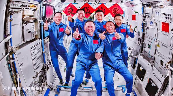 This image captured at Beijing Aerospace Control Center on May 25, 2026 shows a group picture of the crew of Shenzhou-21 and Shenzhou-23 spaceships. The three astronauts aboard China's Shenzhou-23 spaceship have entered the Tiangong space station and met with another astronaut trio on Monday, starting a new round of in-orbit crew handover.  (Xinhua/Jin Liwang)