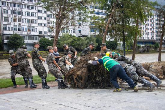Soldiers clear roads and debris as floodwaters recede in Guangxi