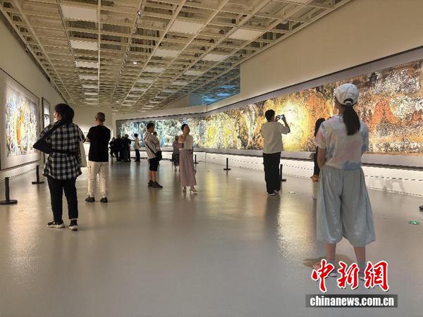 Visitors view exhibits at the Silk Road: Yang Xiaoyang's 40 Years of Silk Road Art and Documentary Exhibition. (Photo courtesy of Shanghai Haipai Art Museum)