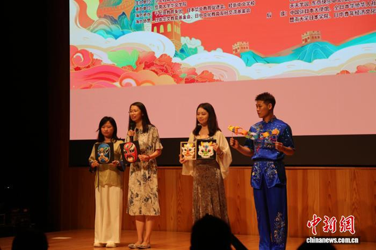 Teachers from Guangdong display handicrafts including Beijing Opera facial masks, July 24, 2026. (Photo: China News Service/Zhu Chenxi)