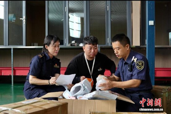 Customs officers inspect export goods. (Photo by Nan Jianglu)