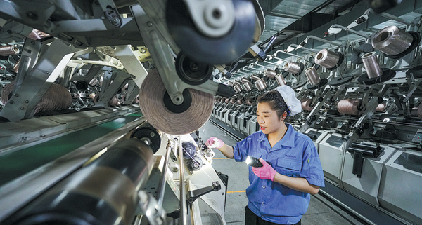 An employee works on the production line of a chemical fiber company in Suqian, Jiangsu province. ZHOU PENG/FOR CHINA DAILY