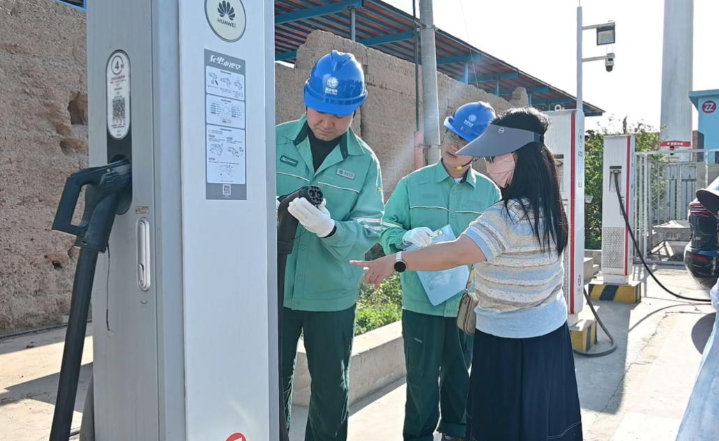 国网新疆电力工作人员在吐鲁番市，开展景区充电站专项排查，面向游客普及充电知识并协助客户进行充电，筑牢旅游出行用电安全防线。蔡俊杰 摄