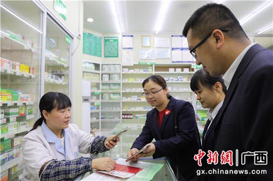 邮储银行贺州市分行开展邮爱公益宣传活动 ,药店工作人员在扫码捐赠。 邮储银行贺州市分行开展邮爱公益宣传活动 ,药店工作人员在扫码捐赠。