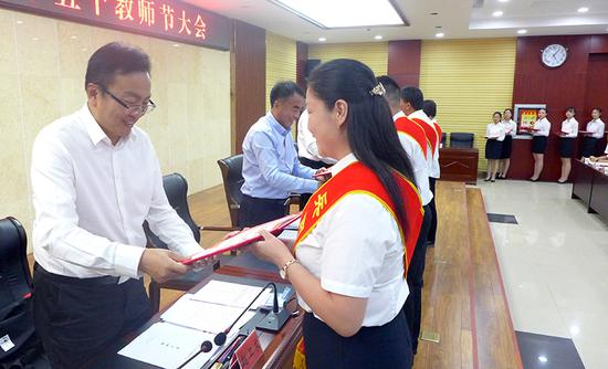 图为师市党委副书记赵卫东向优秀教师颁奖。
