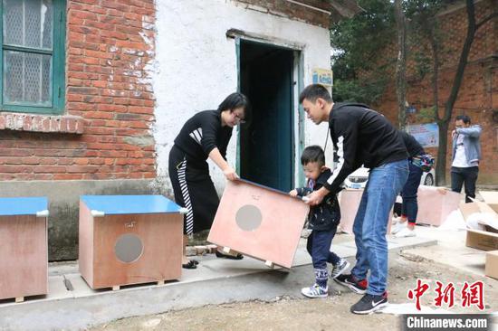 图为一家三口参加搭建猫屋公益活动。 林馨 摄 图为一家三口参加搭建猫屋公益活动。 林馨 摄