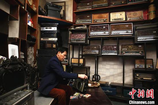 谢志宽在使用1983年购买的收音机。　朱柳融 摄