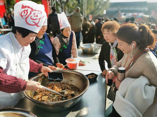 游客村民参加鱼文化节。 颜晗 摄
