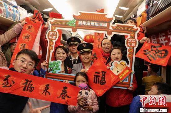 图为务工人员和列车乘务员合影留念。 王东铃 摄 图为务工人员和列车乘务员合影留念。 王东铃 摄