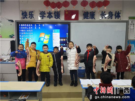 图为桂林市芦笛小学一年级一班期末获奖2斤猪肉的同学。