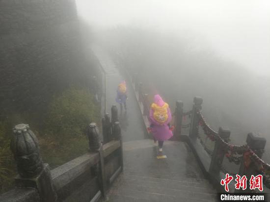 游客雨霧中游覽梵凈山。江口宣傳部供圖 游客雨霧中游覽梵凈山。江口宣傳部供圖