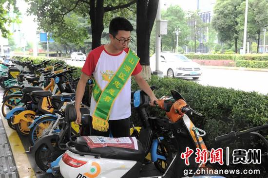志愿者将共享单车进行有序摆放 叶舒 摄 志愿者将共享单车进行有序摆放 叶舒 摄