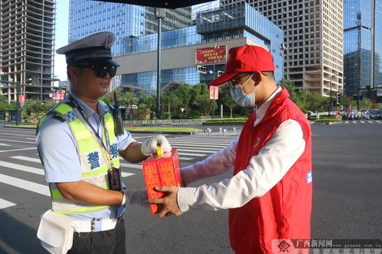 “红马甲”青年志愿者为交警同志送凉茶。通讯员 林慧霞 摄 助力创城:南宁青年志愿者开展系列志愿活动