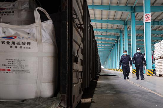 乌鲁木齐铁路公安局哈密公安处罗中站派出所民警对春耕物资进行安全检查。