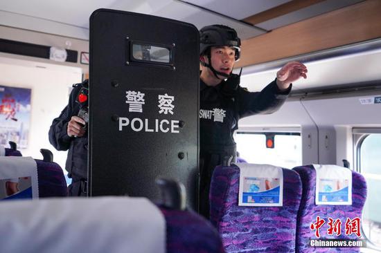 3月18日，上海铁路公安处特警支队在上海南站动车场开展高铁列车抓捕实战化演练，通过演练缩短训练与实战的差距。中新社发 章琦 摄