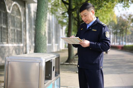 陈优林检查垃圾箱 蒋来 摄