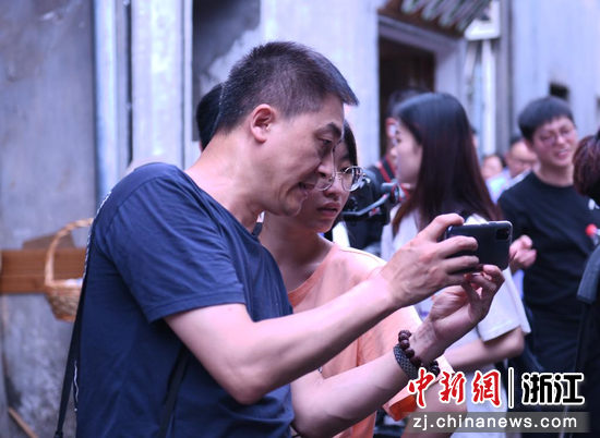 图为：宁波财经学院象山影视学院节目制作系主任李华春指导台湾青年进行手机摄影。 
 干儒森 摄