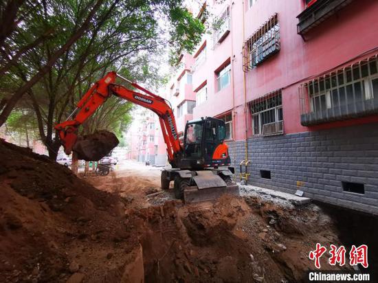 图为昌运公司家属院老旧小区改造项目现场，挖掘机正在施工作业。　刘华 摄