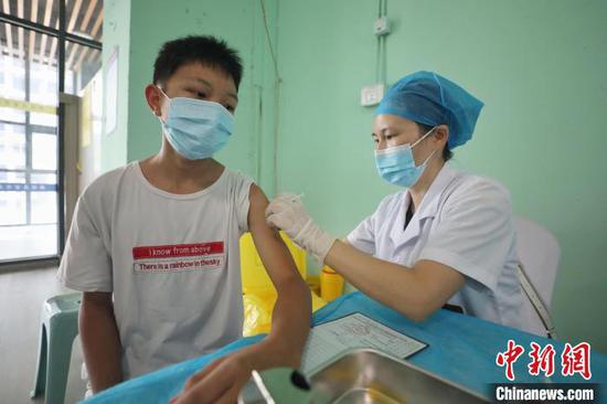 8月7日，贵州省遵义市新蒲新区思乐为新冠疫苗接种点，一名青少年在接种疫苗。　瞿宏伦　摄