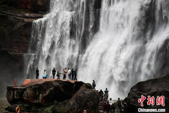 图为游客在贵州赤水大瀑布游玩。　瞿宏伦 摄