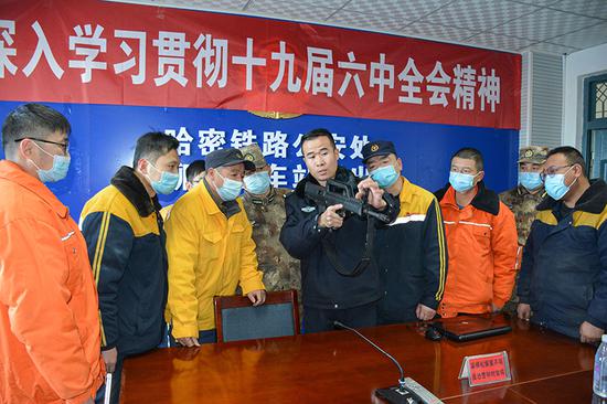红柳河南站派出所民警向职工讲解武器警械。（）